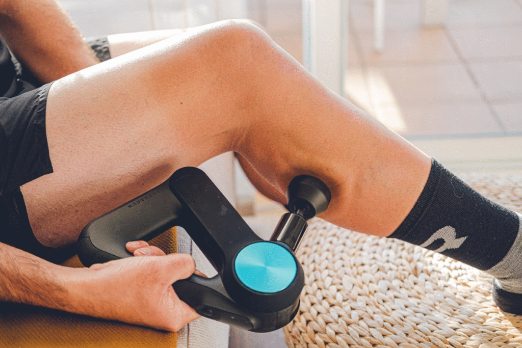 un coureur utilise un pistolet de massage